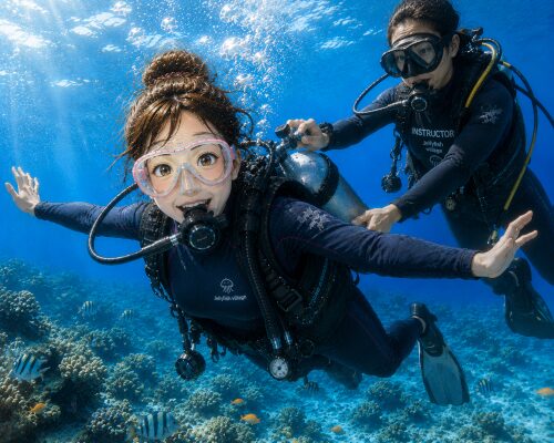 インストラクターにタンクバルブを支えてもらいながら体験ダイビングを楽しむ女性ダイバー